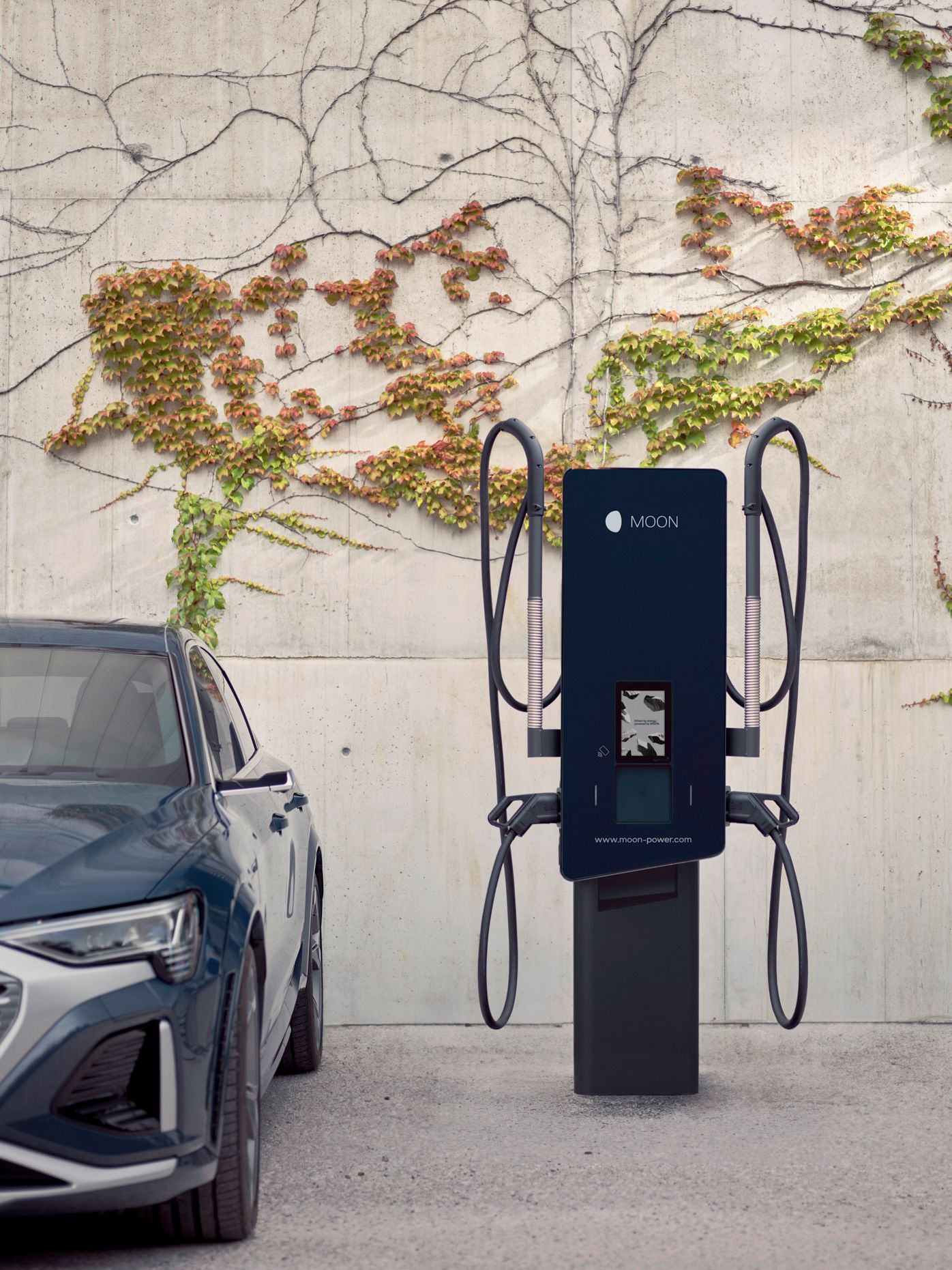 Az autó egy töltőállomás mellett parkol.